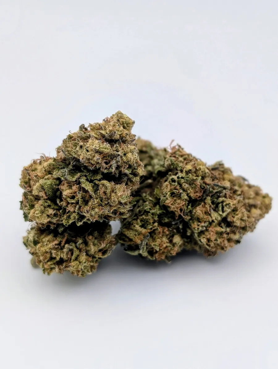 Two Grape Cake cannabis flowers on a light background.